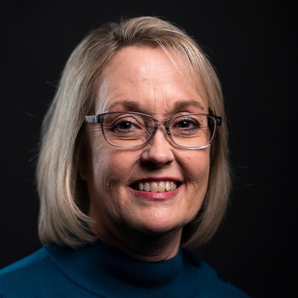 Person wearing glasses and smiling