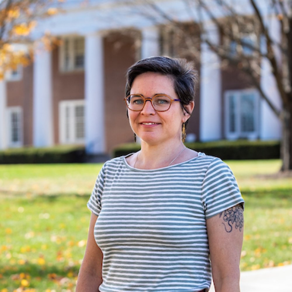person smiling while standing in front of Old Centre