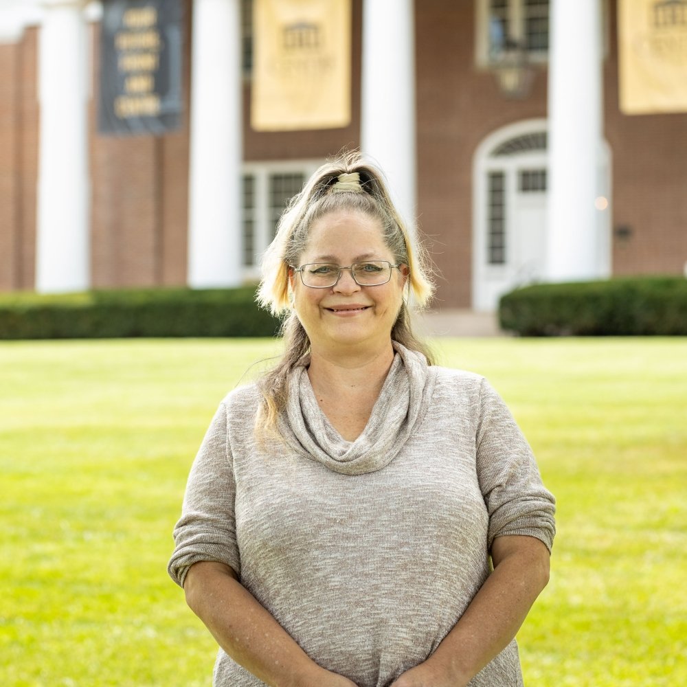 Person wearing glasses and smiling