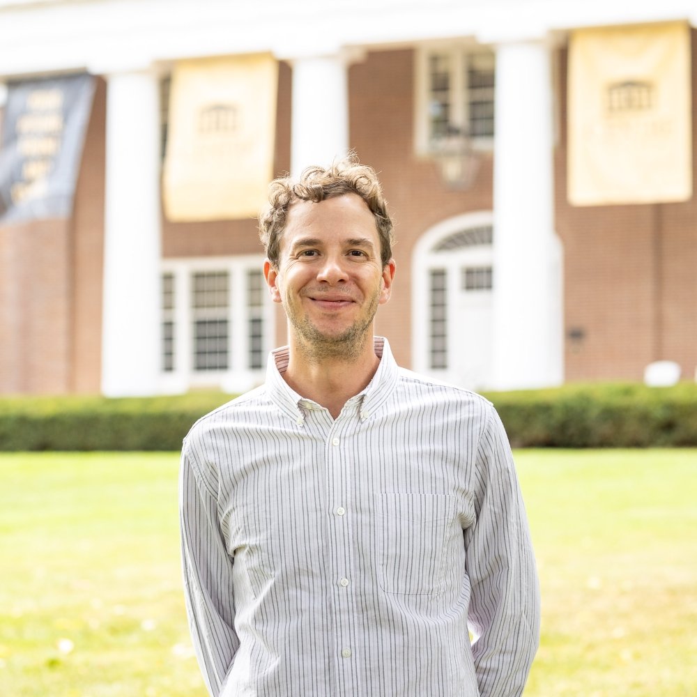 person smiling while standing in front of Old Centre