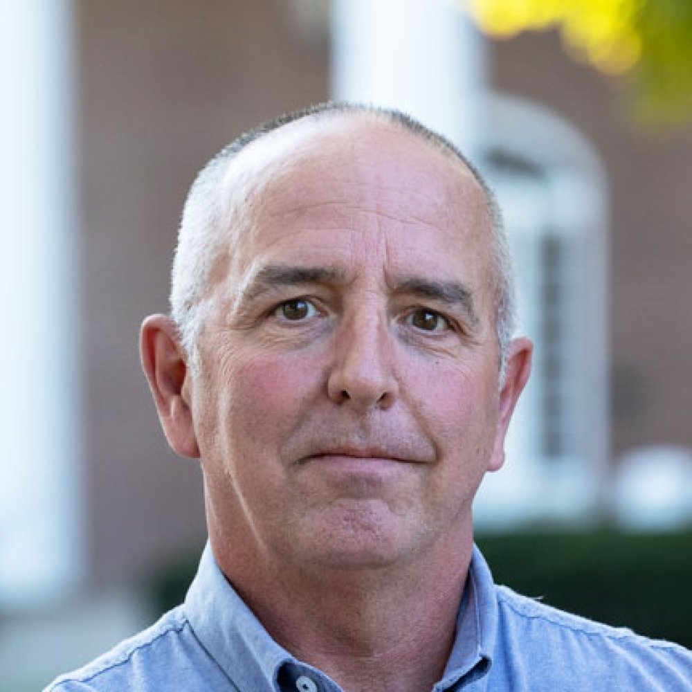 Man with light blue dress shirt standing in front of Old Centre
