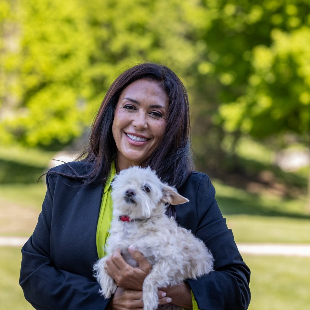 Barbara LoMonaco holding a small dog