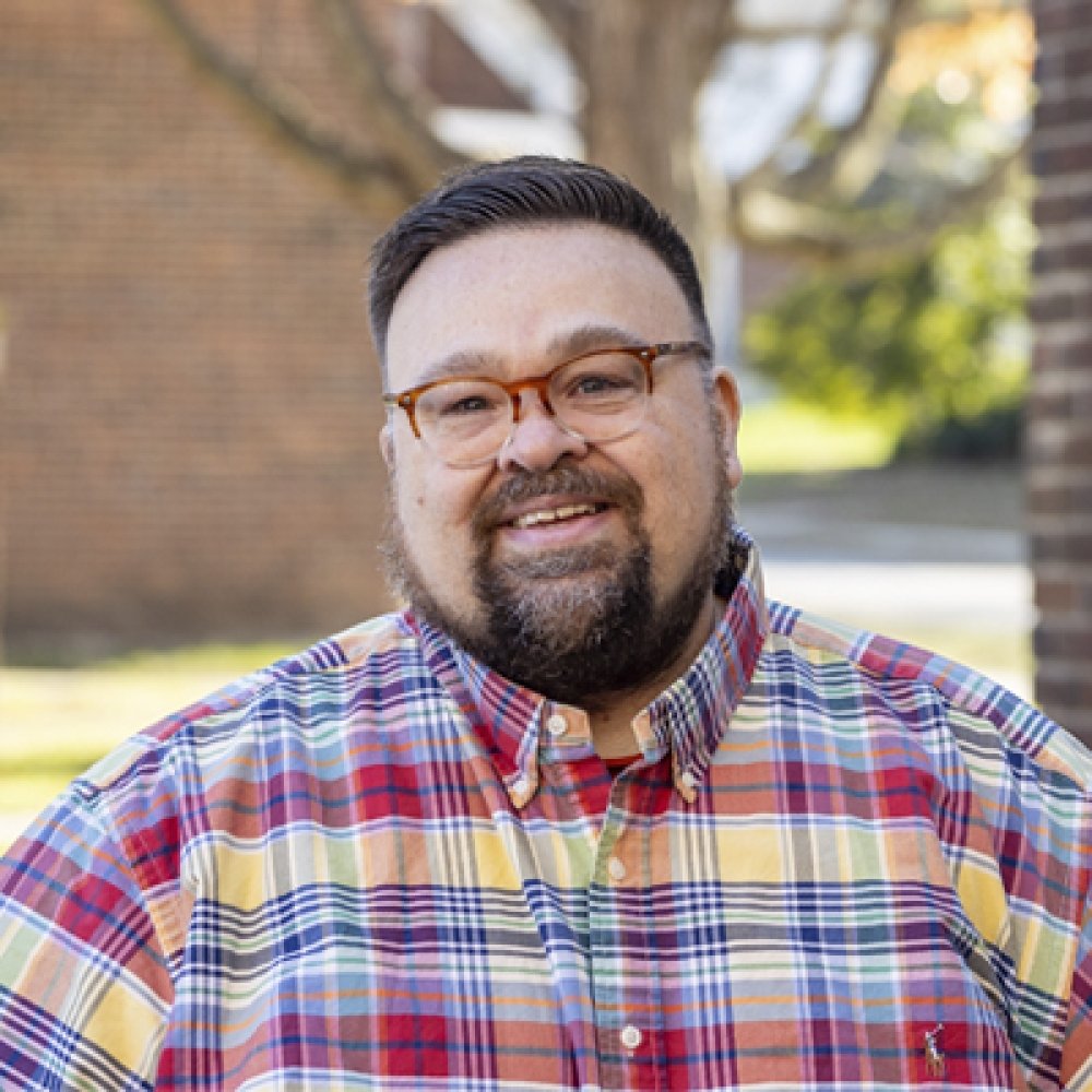 Person wearing glasses and smiling