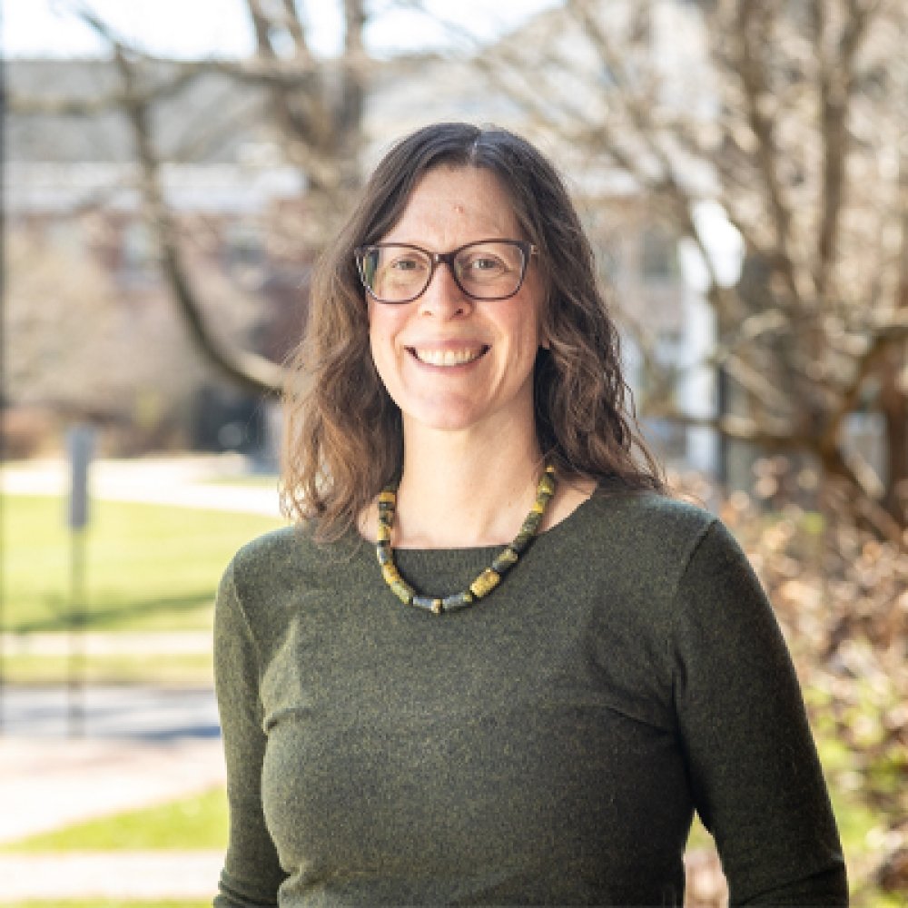 Person smiling and wearing glasses