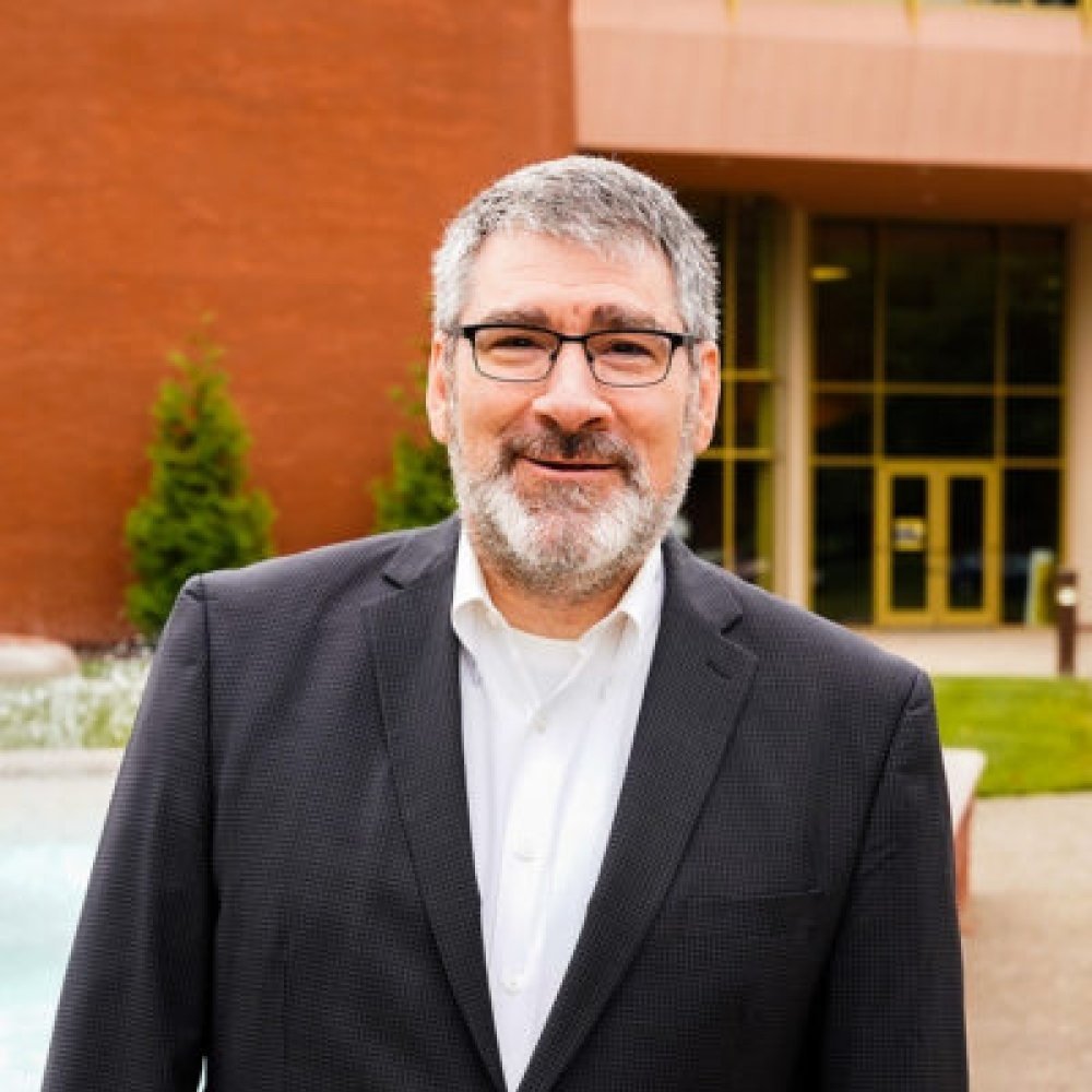 Person wearing glasses and smiling