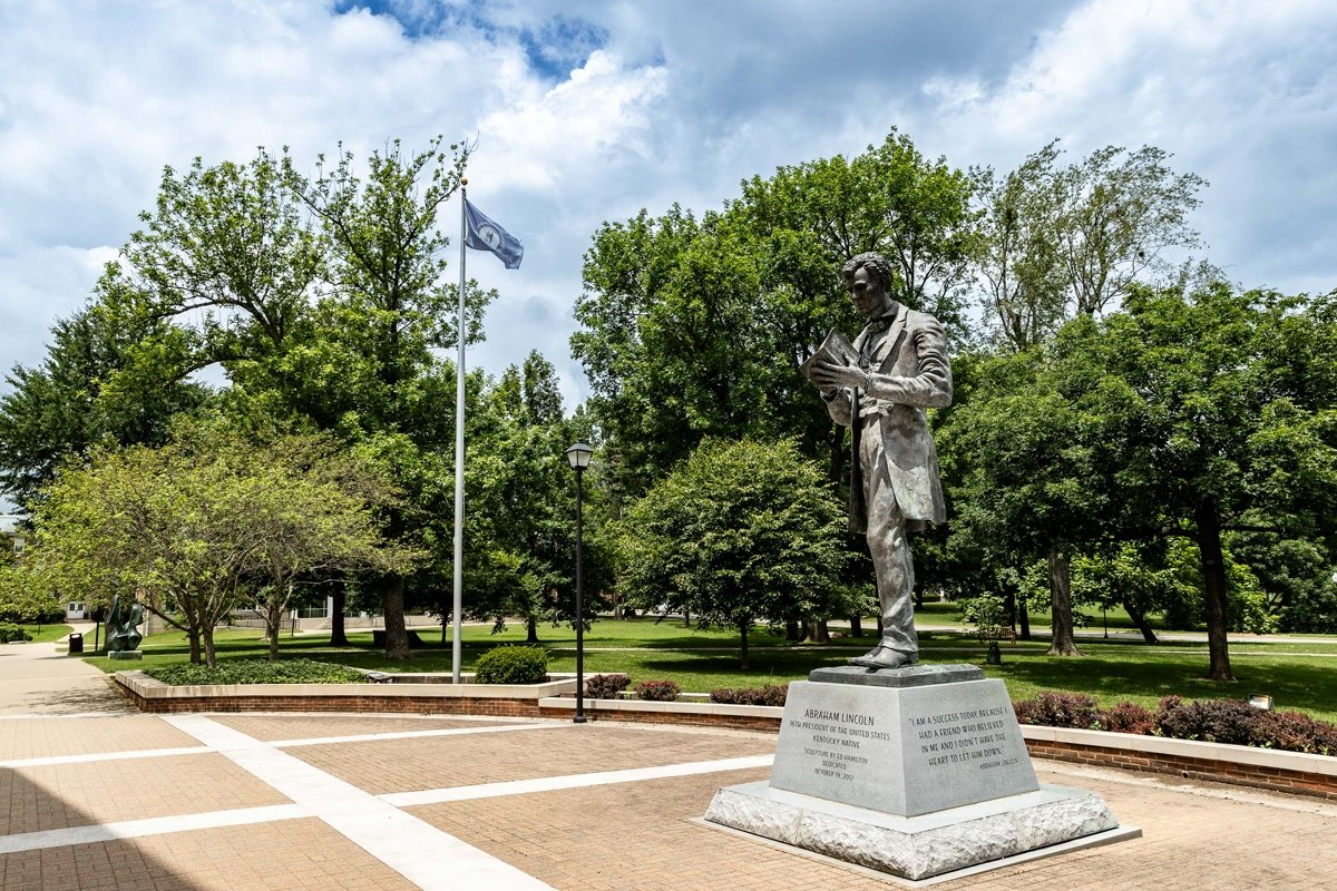 Wide view of Abraham Lincoln statue in front of Crounse Library