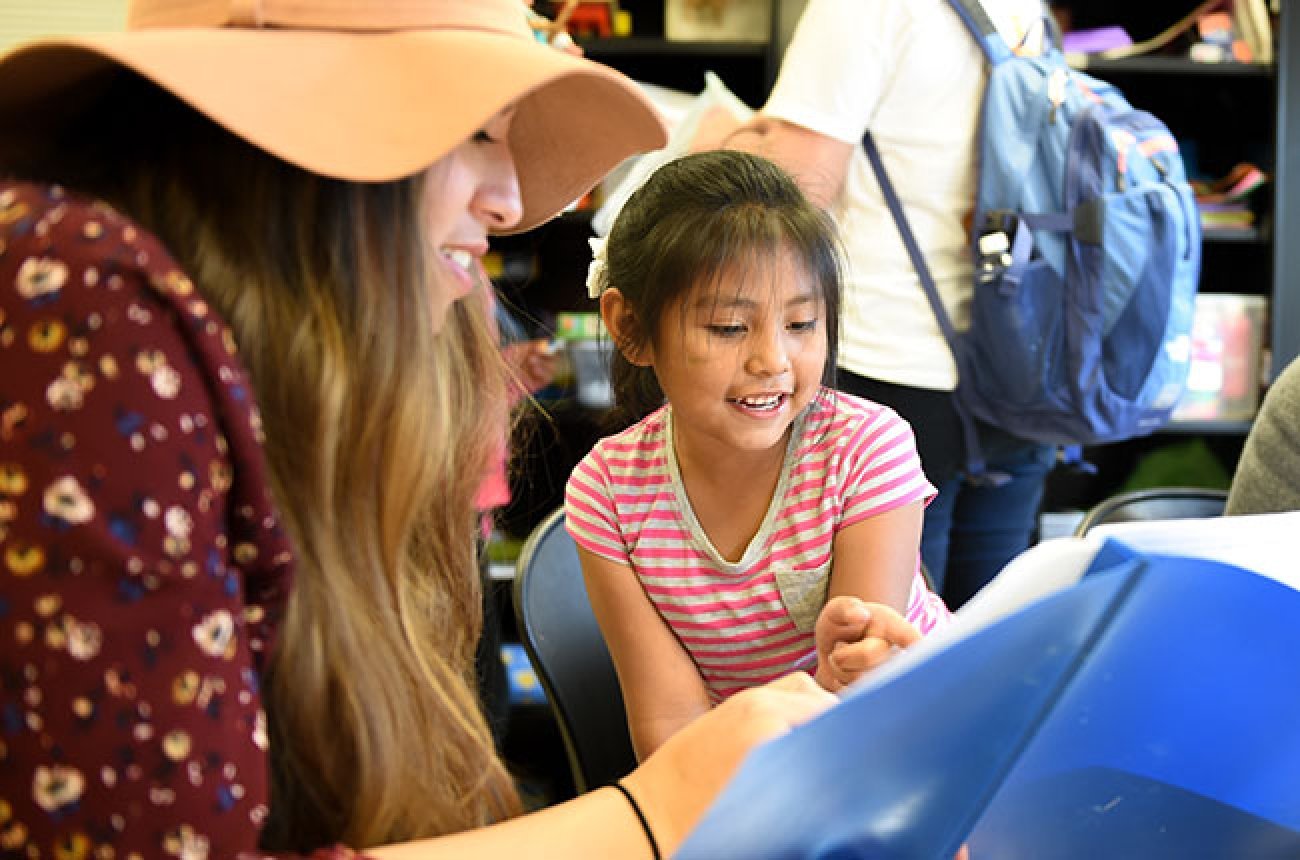 Centre student teaching a child