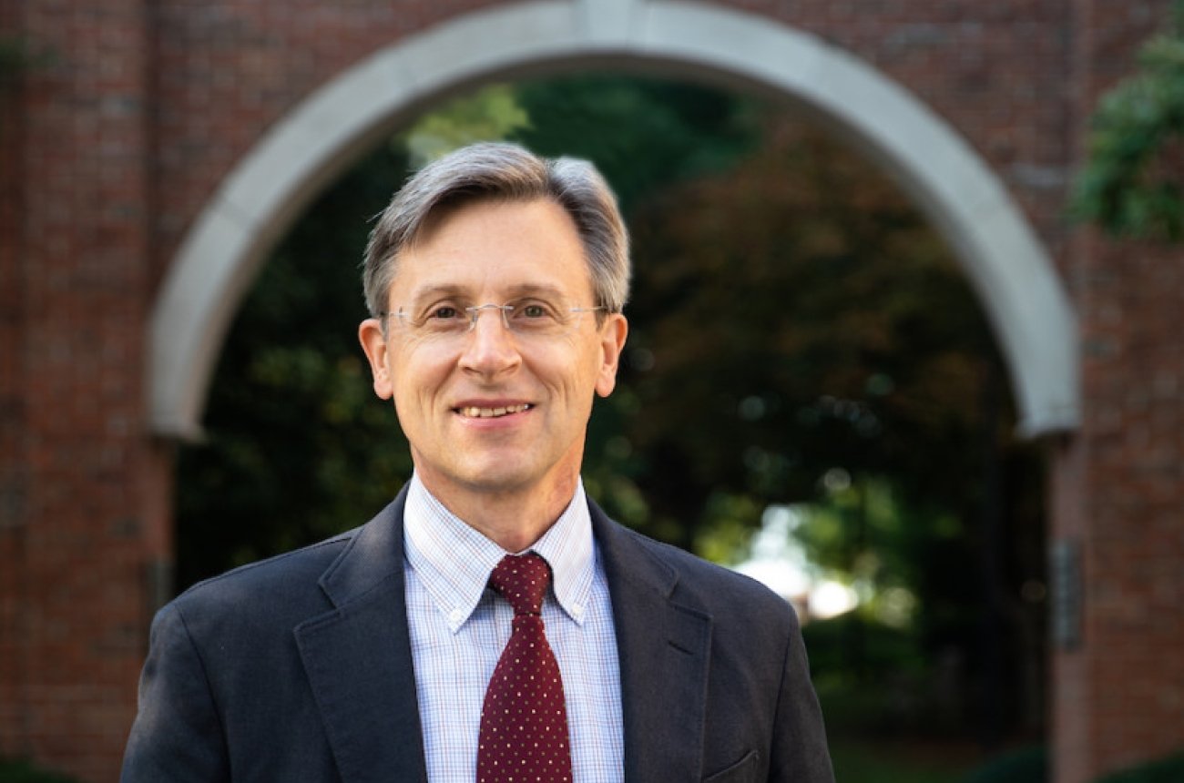 Robert Schalkoff headshot -person wearing glasses and wearing dark sports jacket with light blue shirt and maroon tie