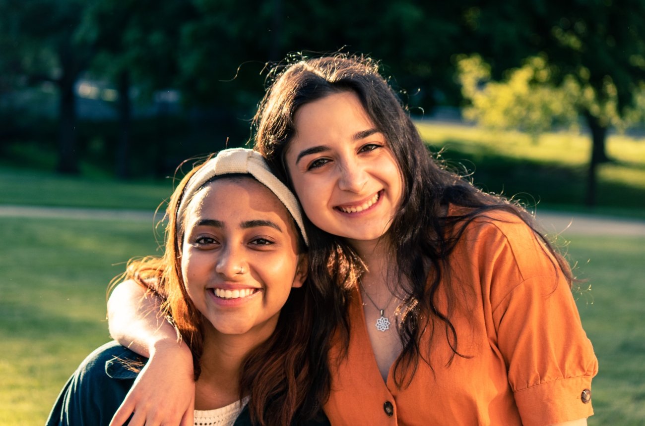 Two students standing in the sun
