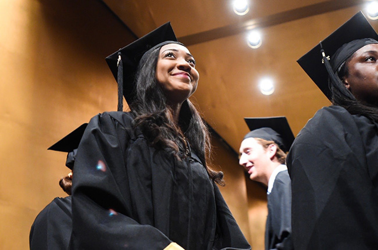 Centre student smiling at graduation ceremony