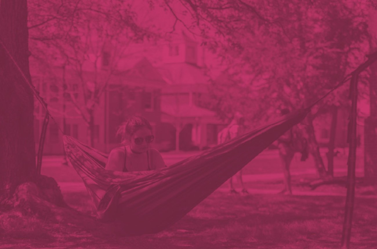 Centre student studying in a hammock on campus