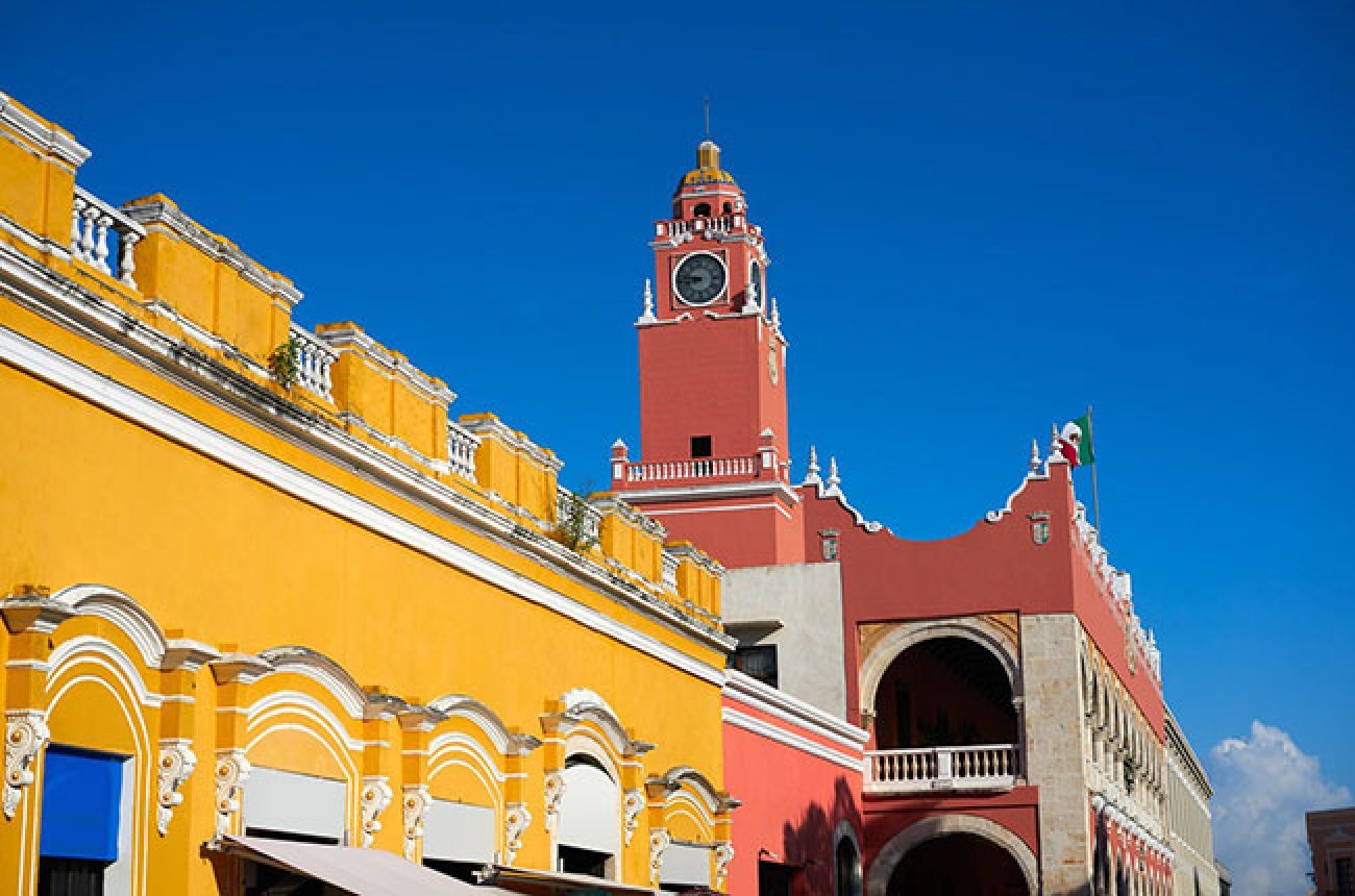 Colorful city architecture against a blue sky near Merida, Mexico
