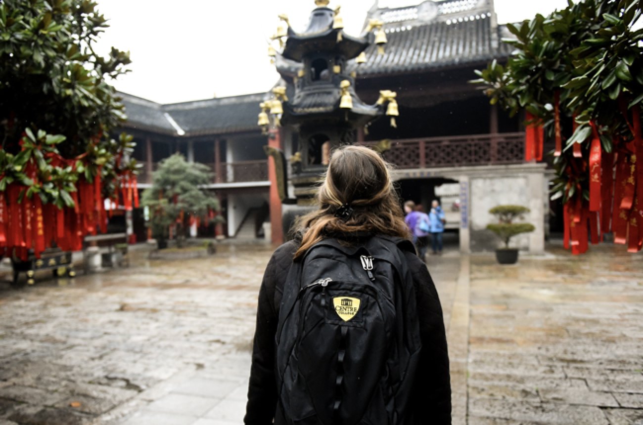 student at temple in Shanghai wearing Centre College backpack
