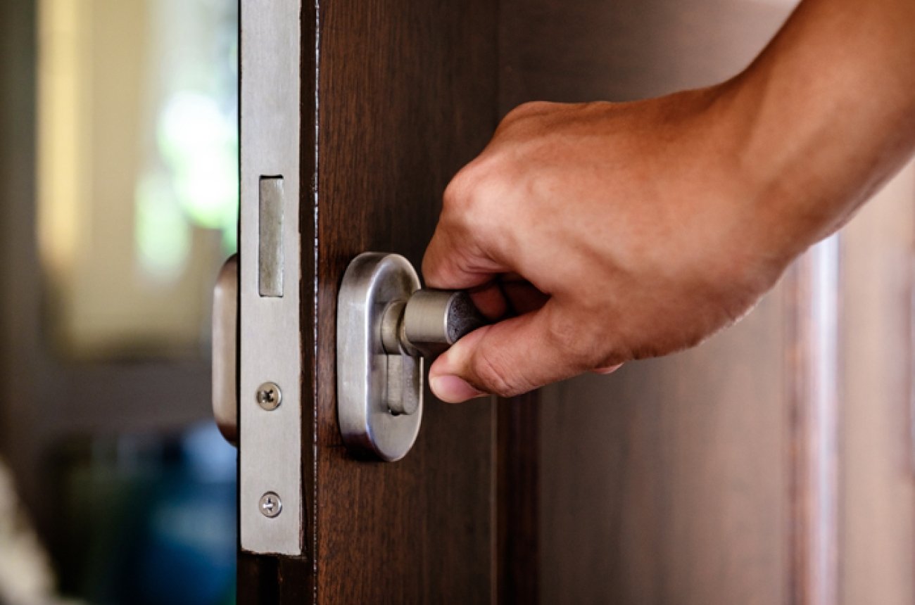 Shutterstock image counseling - person's hand on handle of door