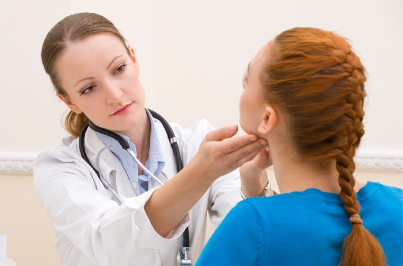 Shutterstock image of doctor examining of patient's neck