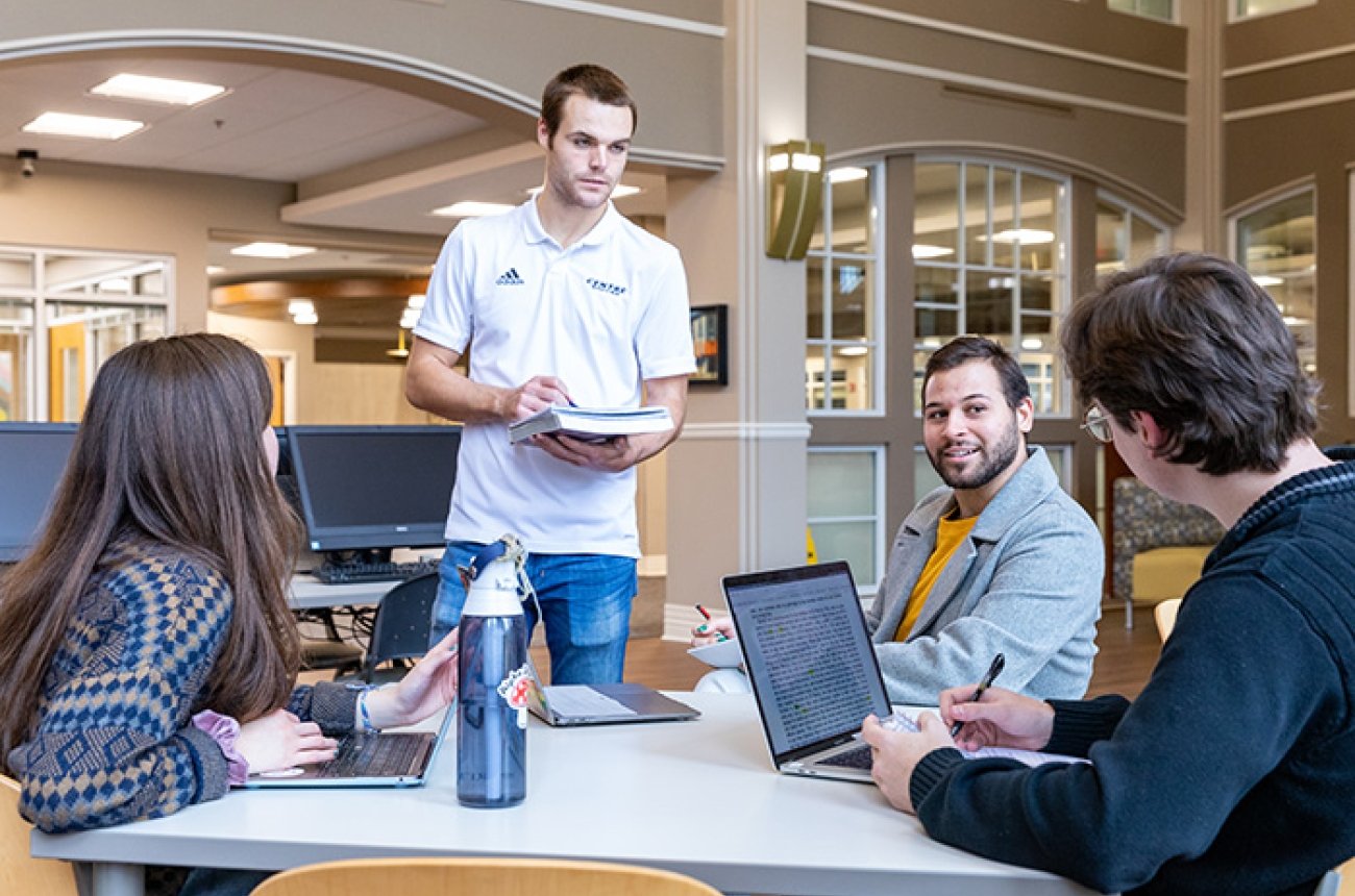 Group of students working together in library on project