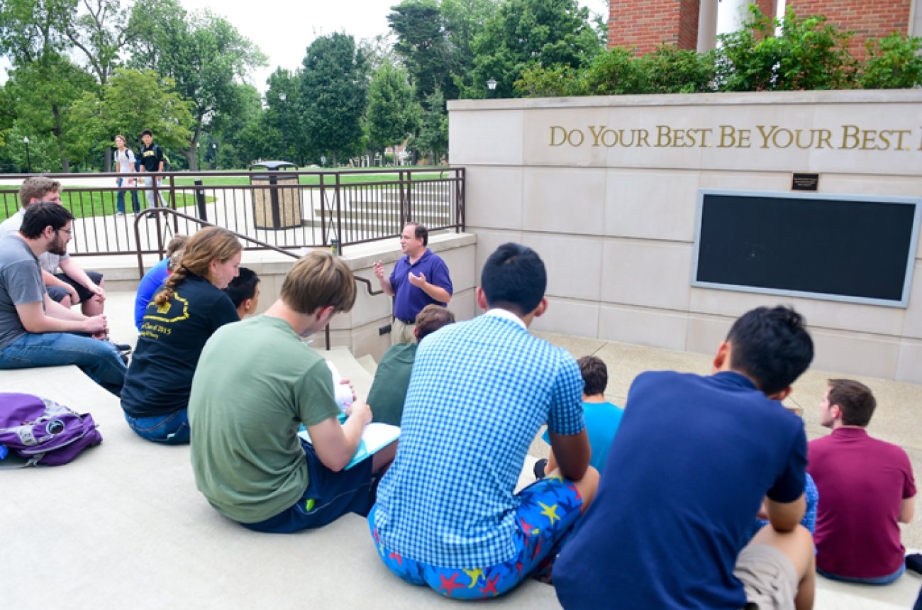 students listening to lecture at outdoor classroom