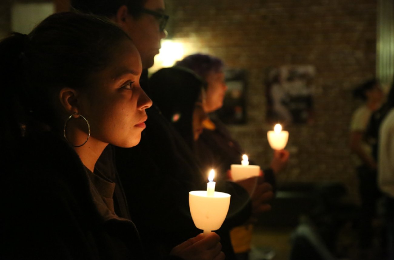 students at candle light vigil for refugees
