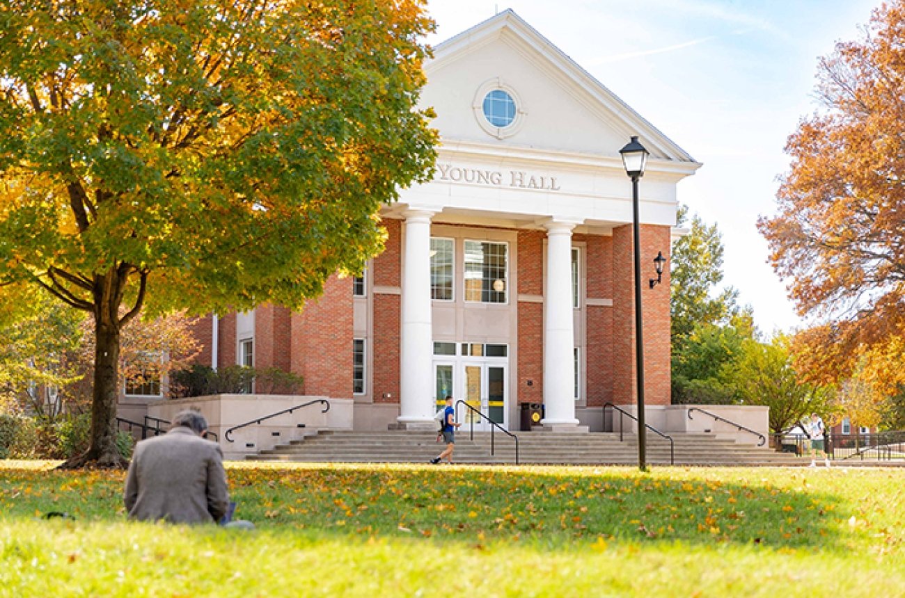 Young Hall and lawn with students in the fall