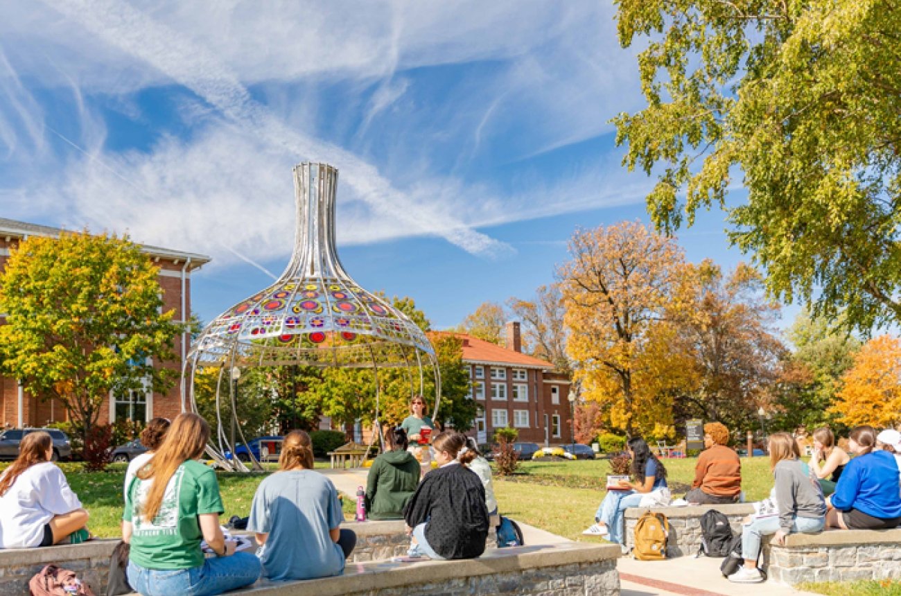 powell memorial garden with students listening to professor in outdoor classroom