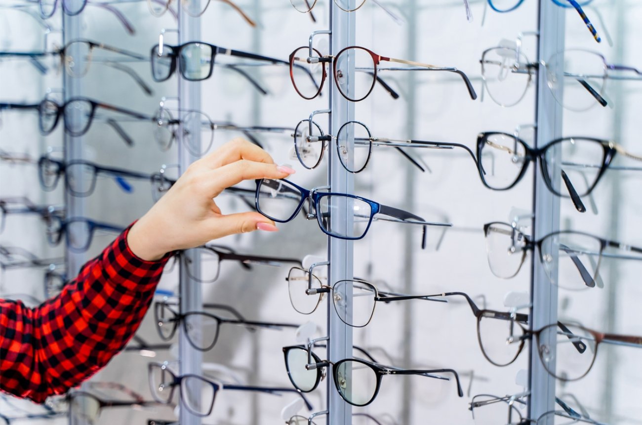 Person picking out glasses at eye doctor office