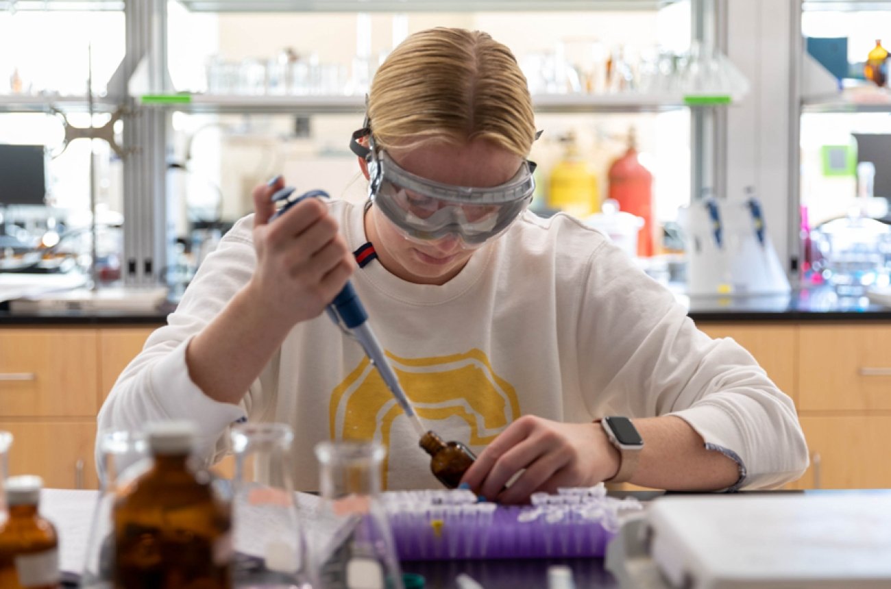Student working on science experiment in lab
