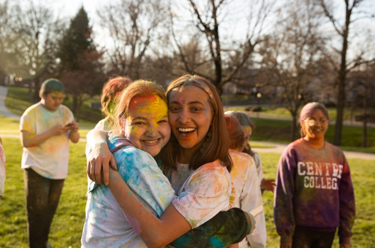 Students hugging looking at camera