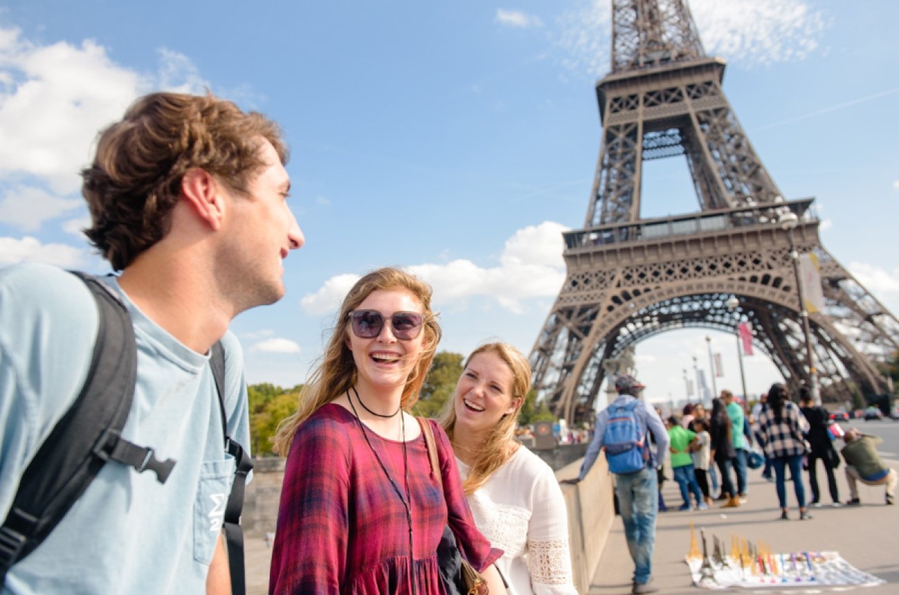 Three students walking in front of the Eiffel Tower