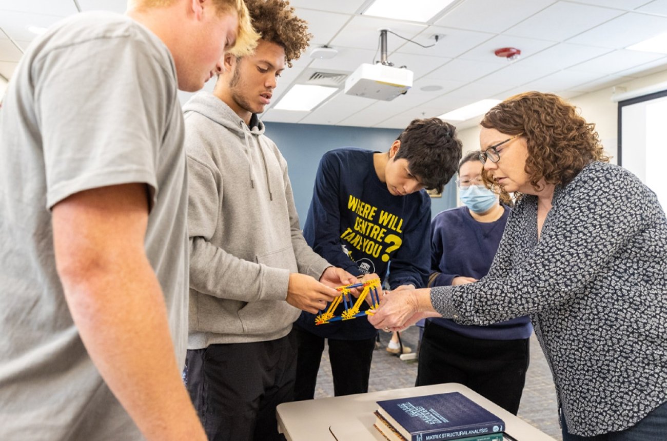 Students working with professor on engineering project