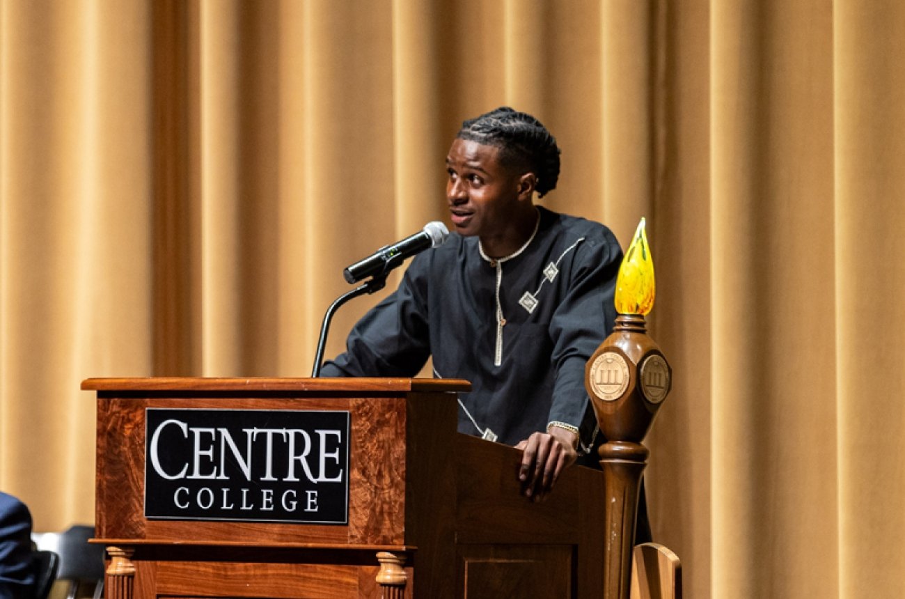 Student at podium giving speech at honors convocation