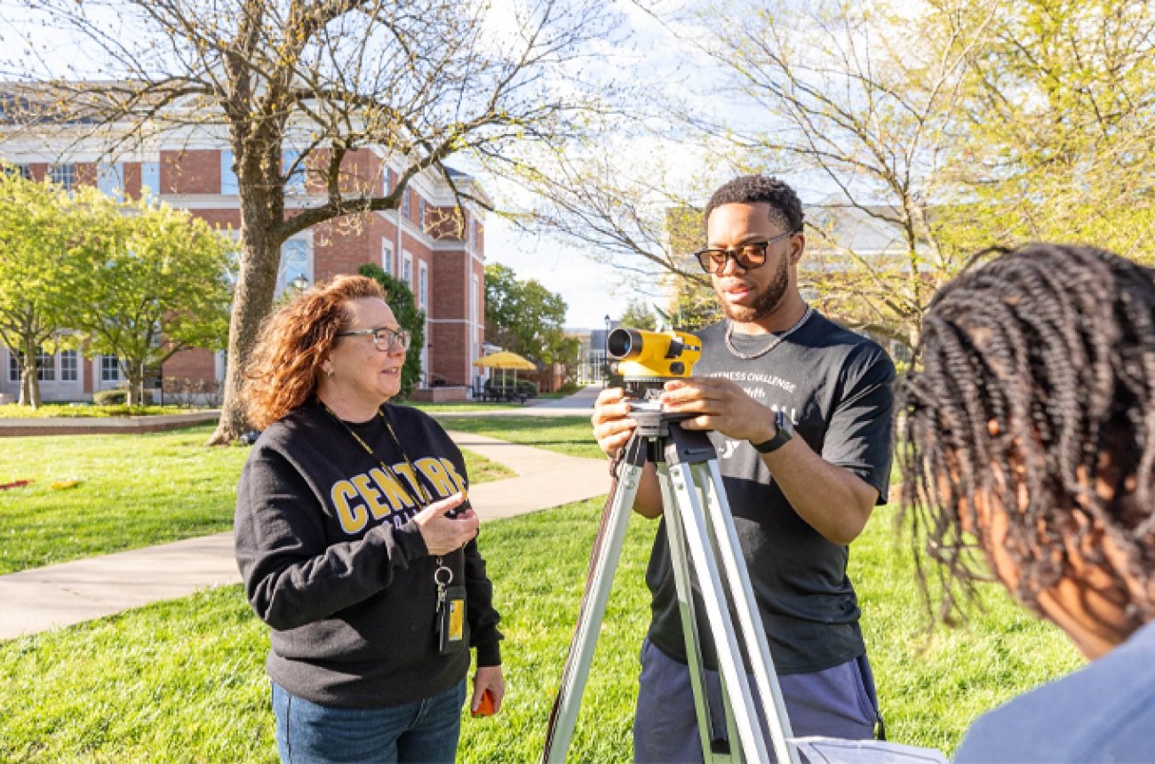 Students surveying in an engineering class outside on campus