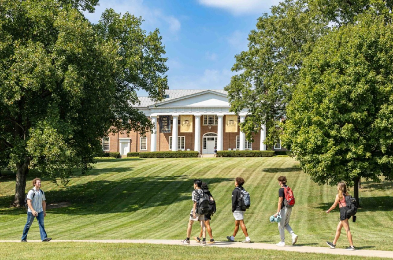 Students walking on campus with Old Centre in the background