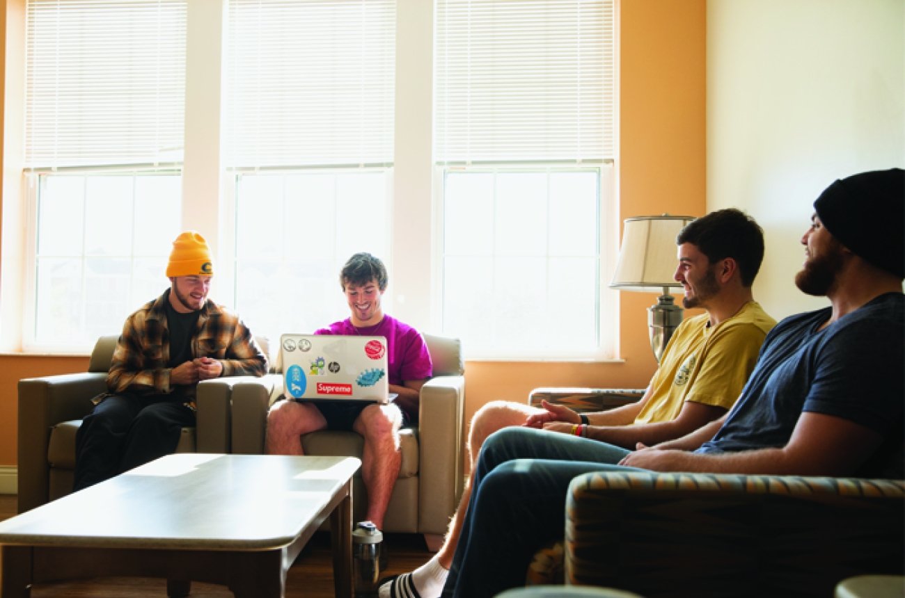 four guys sitting in common area