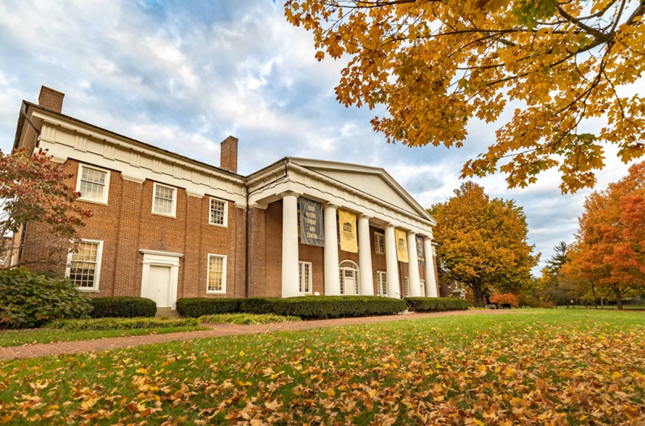 Old Centre building with trees with orange and red leaves in fall