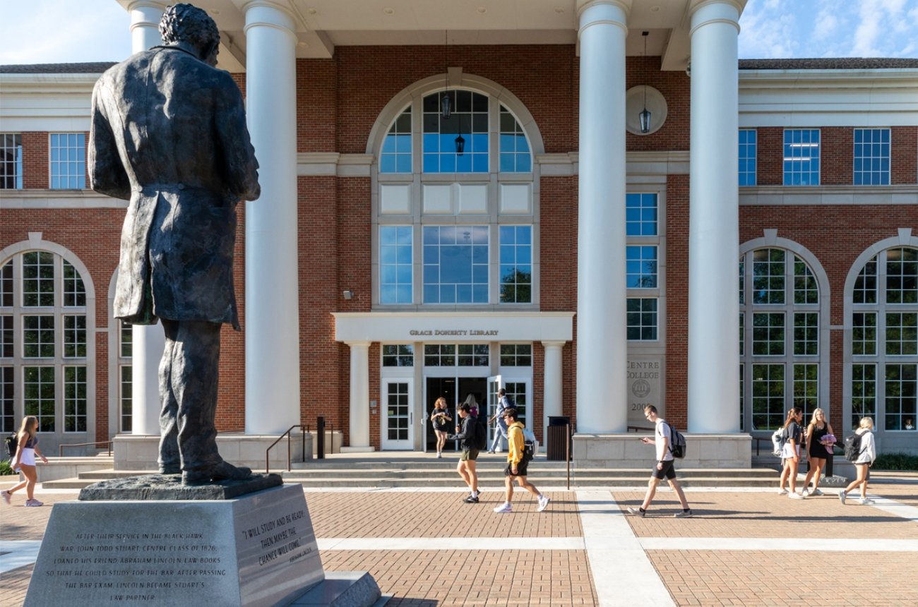 Students walking in front of the library in the spring