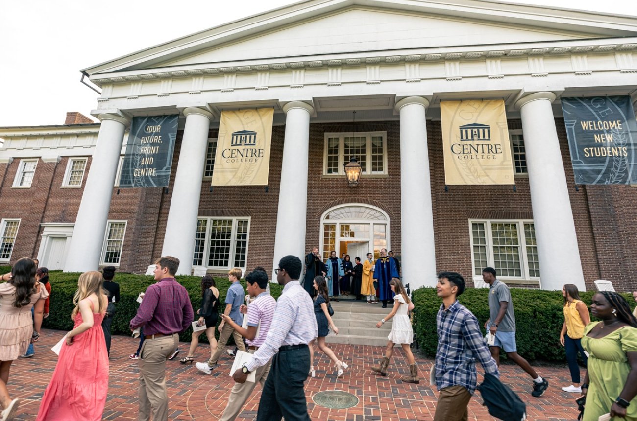 Students walking in front of Old Centre on the way to opening convocation