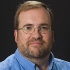 Person wearing glasses and smiling