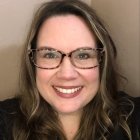 Person wearing glasses and smiling