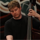 Person playing an upright bass at a music performance