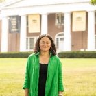 person smiling while standing in front of Old Centre