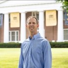 person smiling while standing in front of Old Centre
