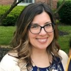 Person wearing glasses and smiling