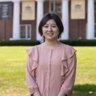 Person wearing pink blouse and smiling at camera