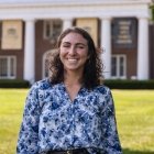 Person wearing blue and white floral top and smiling at camera