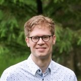 Person wearing glasses smiling