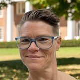 Person wearing glasses and smiling