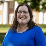 Person wearing glasses and smiling