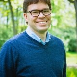 Person wearing glasses and smiling