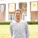 person smiling while standing in front of Old Centre
