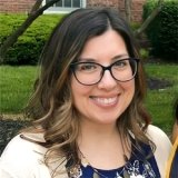 Person wearing glasses and smiling